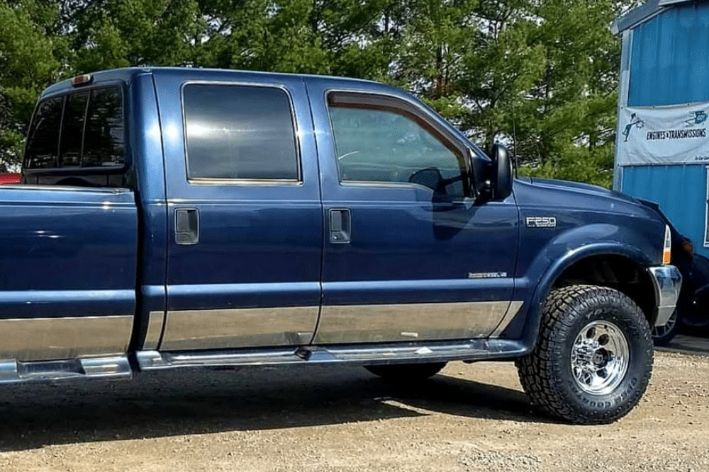 Chevy and Ford Truck Repair in Millersport, OH at Kreager Tire & Service. Image of Blue Ford pickup truck parked at a service shop.