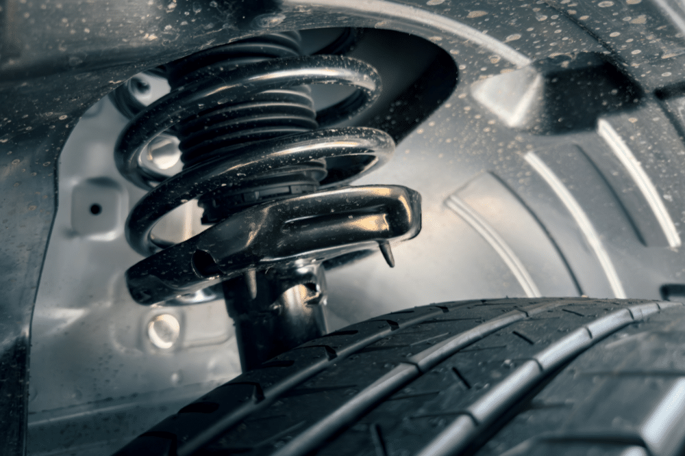 Steering and Suspension Service in Millersport OH at Kreager Tire and Service. Close-up of a vehicle suspension strut and new tire